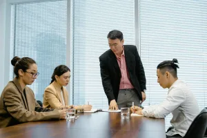A diverse group of professionals engaged in a collaborative business meeting, discussing ideas.