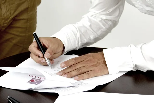 person signing a document